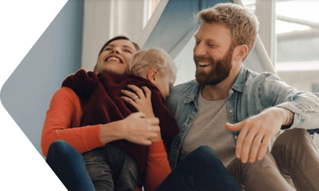 Parents and an infant relaxing in their home